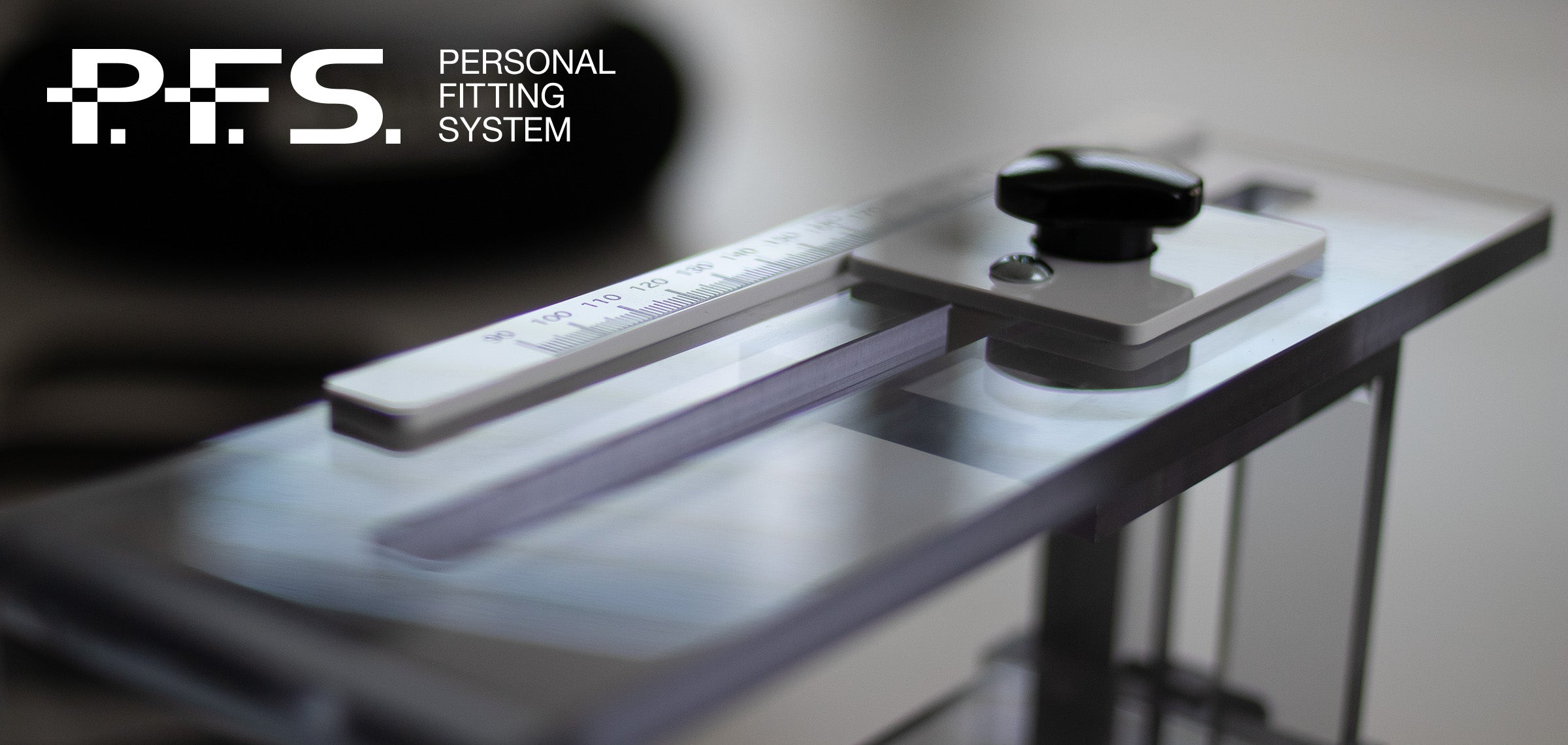Personal Fitting System (P.F.S.) device on a table with a blurred background